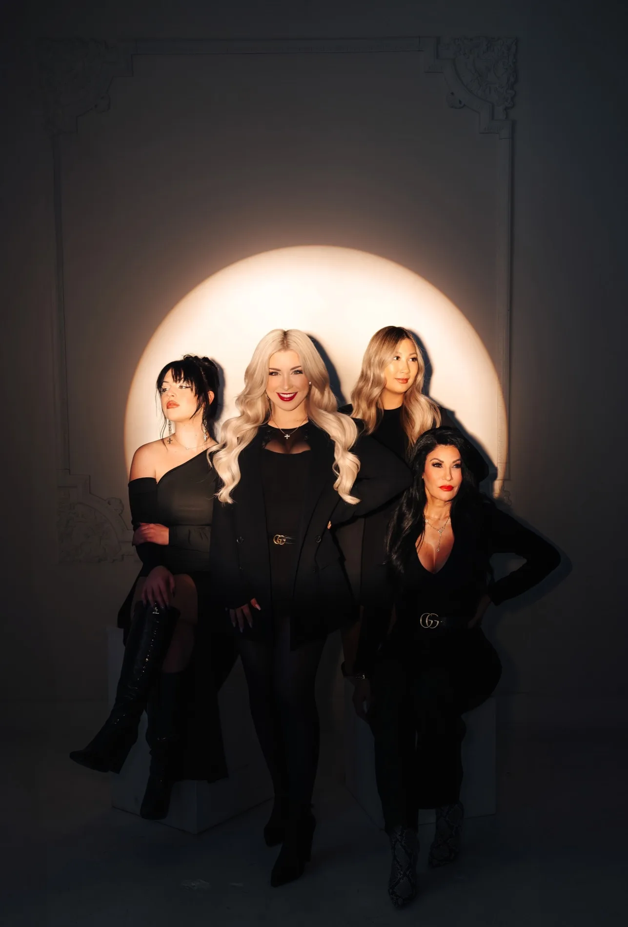 The Beauty Society by Gina team styled in black against a soft spotlight
